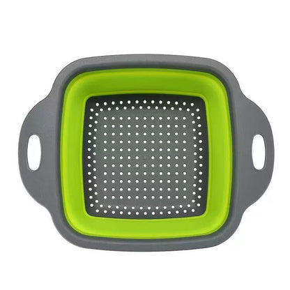 Foldable silicone vegetable storage basket in square shape with green interior and grey exterior.