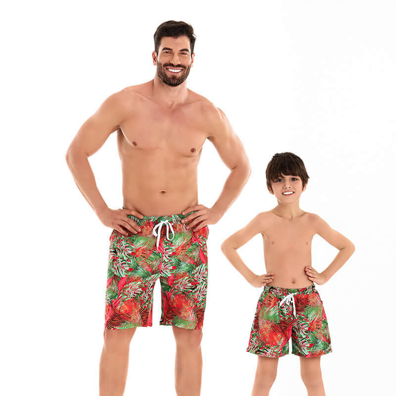 Family matching swimwear set featuring dad and son in colorful floral swim trunks, perfect for summer fun together.